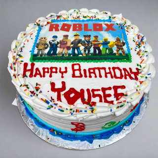 Roblox Scan round birthday cake with white frosting, colorful sprinkles, and an edible Roblox image. "Happy Birthday Yousef" is written in red icing.