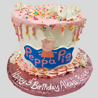A pink and white Peppa Drip cake with sprinkles, whipped cream, and a Peppa Pig logo, featuring “Happy 3rd Birthday Aleah Rose” in white icing on the base.