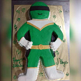 The Power Ranger Cutout birthday cake, inspired by kids characters and shaped like a green Power Ranger with detailed accents, features custom pricing. "Happy 4th Birthday JKhye" is inscribed on the gold cake board.