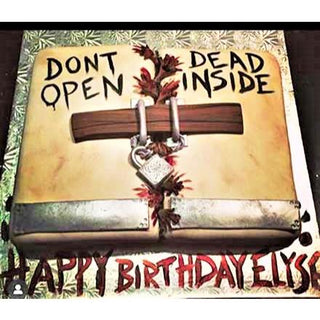 A birthday cake inspired by the Walking Dead Box, styled as chained double doors with "DON'T OPEN DEAD INSIDE" and "HAPPY BIRTHDAY ELYSE!" in bold black and red—perfect for fans and kids.