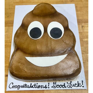 The Emojii Cutout is a custom birthday cake shaped like a smiling poop emoji, with large eyes and a white mouth, sitting on a white board that says "Congratulations! Good Luck!" in black icing—ideal for specialty birthday designs.