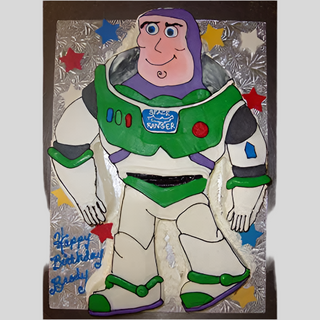 The Toy Story Cutout cake is shaped like Buzz Lightyear, decorated with colorful stars, and has "Happy Birthday Brady" in blue icing on the bottom left—a perfect treat for fans of kids’ characters!.