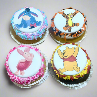 Winnie Scans: Set of 4 cupcakes topped with edible decorations of Eeyore, Tigger, Piglet, and Winnie the Pooh. Custom cake pricing is available upon request.