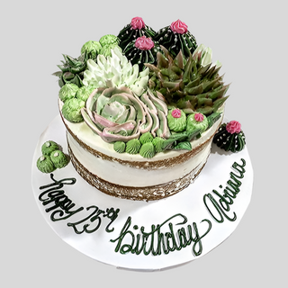 The Naked Cactus is a round custom birthday cake topped with buttercream succulents, finished on a white board with green icing that reads "Happy 23rd Birthday Adriana.