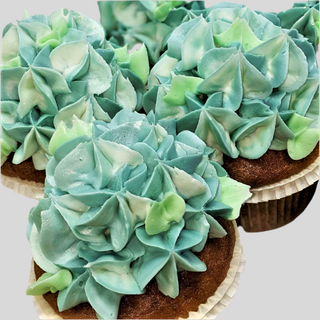 Hydrangea Colors: Chocolate cupcakes topped with blue, green, and white floral frosting, artfully arranged as a custom hydrangea cake display—ideal for special events or as an elegant wedding cake alternative.