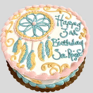 Dream Catcher round specialty birthday cake with a custom pastel pink, yellow, and blue dream catcher design. "Happy 3rd Birthday Sai Priya" in blue and yellow icing, finished with pink and yellow frosting borders.