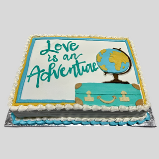 The "Travel Adventure" cake is rectangular with a globe, suitcase, and “Love is an Adventure” in blue and green icing. It features white icing and blue, yellow, and white borders for an anniversary celebration.