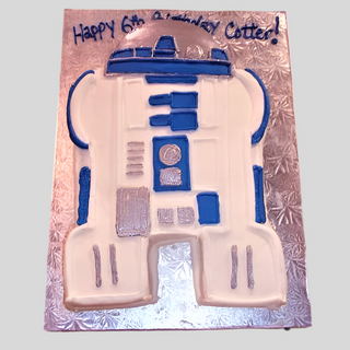 A Star Wars R2-D2 birthday cake for kids, decorated with blue and white icing on a silver board. The message says, "Happy 6th Birthday Cater!" Perfect for fans of Star Wars R2-D2.