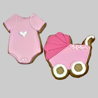 Girl Baby Cookies: one pink onesie with a white heart and one pink stroller with white wheels, perfect for baby showers or new arrivals. Set against a light gray background.