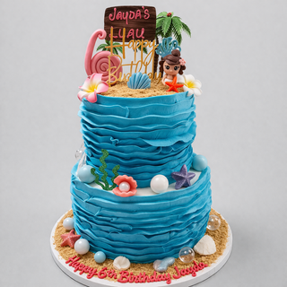 A two-tiered Hawaiian Luau birthday cake with blue ruffled icing, sandy decor, seashells, flowers, a “Jayda’s Luau Happy Birthday” topper, and “Happy 6th Birthday Jayda” written on the base.