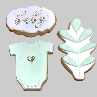 The Golden Baby set includes three decorated cookies: a cloud with “baby” in gold icing, a mint green onesie with a gold heart, and a leafy branch—ideal for adorning baby shower cakes or custom cake displays.