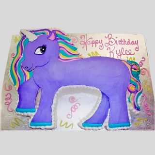 Perfect for kids’ parties, the Pony Cutout is a unicorn-shaped birthday cake with purple icing, a rainbow mane and tail, and “Happy Birthday Kylee” in pink icing. A slice is missing from the pony’s midsection.