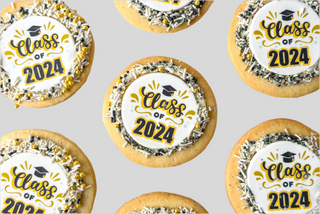 The Grad Scan Cookie features sugar cookies topped with white icing, black and gold sprinkles, and an edible "Class of 2024" graduation cap topper, all set against a light gray background.