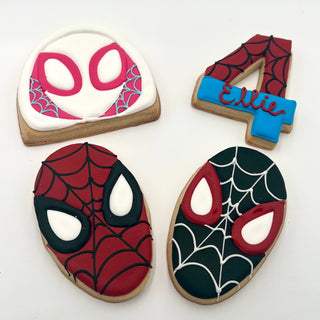 Spider-Man Assorted: four decorated cookies—a white and pink Spider-Gwen mask, a red number 4 with "Ellie," a red Spider-Man mask, and a black Spider-Man mask—each with web designs on white backgrounds.