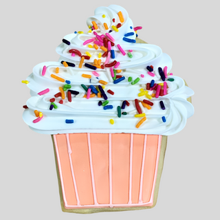 The Cupcake Cookie features a pink icing base, white swirled top, and rainbow sprinkles—ideal for birthday celebrations. Displayed on a plain light gray background.