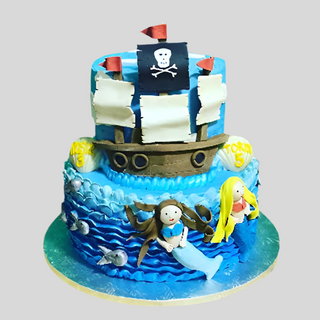 The Pirate Tier is a two-tiered blue cake with ocean wave designs, fondant mermaids, a ship, skull and crossbones flag, and sea creatures—perfect as a custom kids birthday cake!.