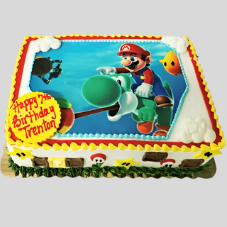 The Mario Scan is a rectangular custom cake with an edible image of Mario riding Yoshi, bordered by yellow, red, and white icing. Kids' characters and Mario icons decorate the sides. A yellow plaque says "Happy 7th Birthday Trenton.