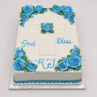 Floral Religion: A rectangular white cake featuring a decorative cross, blue and white icing roses, and "God Bless RJ" written in blue icing on top.