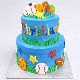 The Sports Tier is a two-tier blue cake with colorful stars, sports balls, green icing grass, and "Christian" in multicolored letters—perfect for birthdays or baby showers.