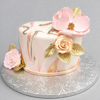 The Marble Floral cake features pink and gold accents, realistic pink flowers, and gold leaves on a silver embossed board—an elegant choice for those seeking specialty birthday designs.