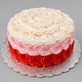 Colorful Rosettes is a custom birthday cake with specialty buttercream pink rosettes in three layers—white, pink, and red—displayed on a silver patterned board against a gray backdrop.