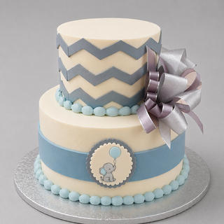 Chevron Tier is a two-tier custom cake with blue and gray chevron patterns, ribbon accents, and a silver-gray bow topper. The bottom tier includes a blue band and an elephant-with-balloon plaque—ideal as a baby shower cake.