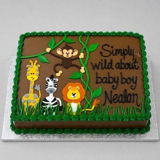 The Safari Chocolate cake is rectangular, decorated with cartoon giraffe, zebra, lion, and monkey plus green icing vines. The custom message reads: “Simply wild about baby boy Nealan.”.