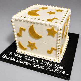 The Moon Block is a white, cube-shaped cake adorned with gold stars, moons, and music notes, bordered with gold beads. It sits on a black board reading "Twinkle Twinkle Little Star..."—perfect for a baby shower.