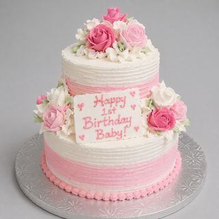 The Stripe Tier cake features two pink and white striped tiers with icing roses, a “Happy 1st Birthday Baby!” plaque in pink icing, and sits on a silver board. Custom pricing available for this specialty birthday cake.