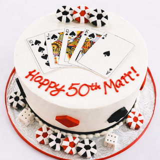 The Poker Hand cake features playing cards, poker chips, dice, and red icing text "Happy 50th Matt!" on white. Ideal for poker lovers or sports & hobby-themed parties. Contact us for pricing.