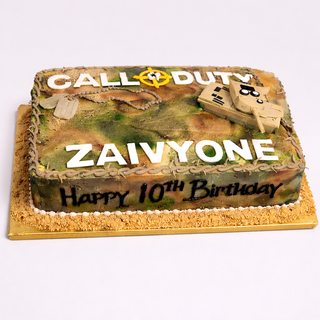 The Call Duty Camo birthday cake features a fondant tank, dog tags, and "CALL OF DUTY, ZAIVYONE, Happy 10th Birthday" on a golden board—ideal for hobby fans. Contact us for custom Call Duty Camo cake pricing.