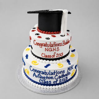 The Grad Tier cake is a custom two-tiered graduation centerpiece, topped with a black cap and inscribed with congratulatory messages for Bubba (NQHS) and MK (Arlington Catholic), class of 2013—perfect for any party.