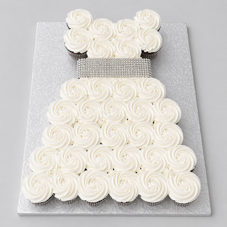 Cupcake Bling: Cupcakes arranged as a dress with white swirled icing and a sparkling silver belt, displayed on a textured silver board—perfect bridal cupcakes.