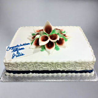 A rectangular white Callalily Scroll cake decorated with white and burgundy flowers, a dark ribbon on the sides, and "Congratulations Allison Julia" written in blue icing.