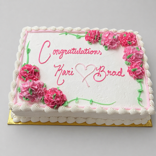 The Hydrangea Floral cake is a rectangular custom birthday cake with white icing, pink and green hydrangea-inspired flowers, a pink border, green vines, and "Congratulations Kari ♥ Brad" written in pink script.