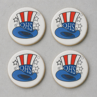 Four Quincy Cookies, each round and decorated with a red, white, and blue Uncle Sam hat featuring a blue brim, white stars, and "QHS" in blue, are arranged in a 2x2 grid on a gray background.