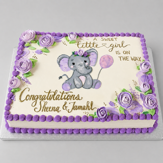 The "Elephant Florals" cake is rectangular with purple icing roses and trim, featuring a gray elephant holding a balloon. Text: “A sweet little girl is on the way. Congratulations Sheena & Jamahl.”.