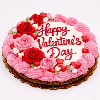 The Valentines Cookie Cake is a round cake with pink and white frosting, red and pink icing roses, and “Happy Valentine’s Day” written in red icing on top.