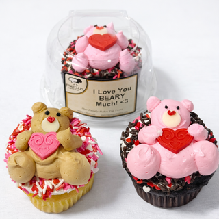 The Valentines Bear set includes three cupcakes topped with bear-shaped icing figures holding red hearts—two pink bears and one brown—with a label reading “I Love You BEARY Much! <3” on one cupcake.